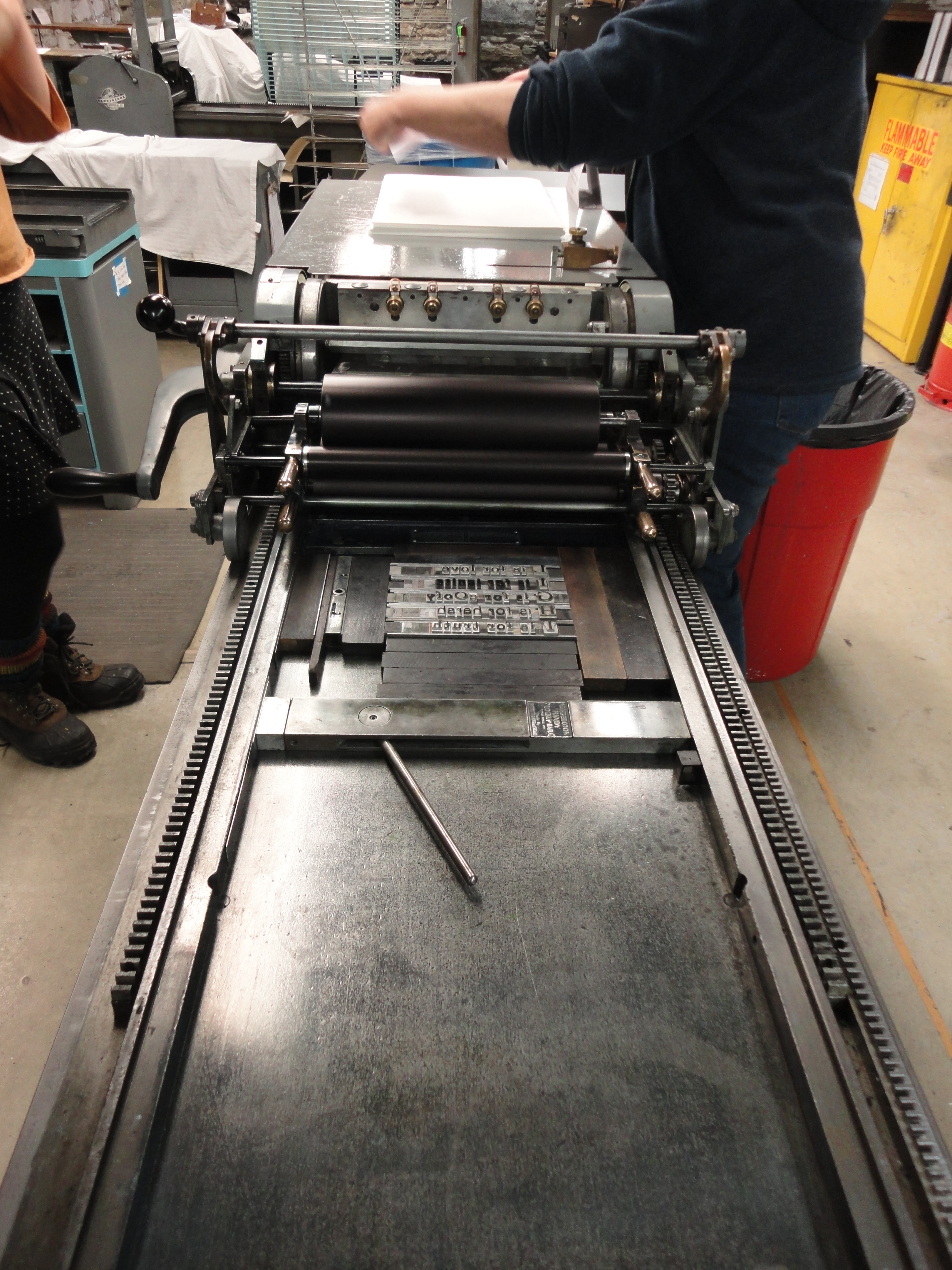 Once the type is locked into place on the press bed, the printing can begin.