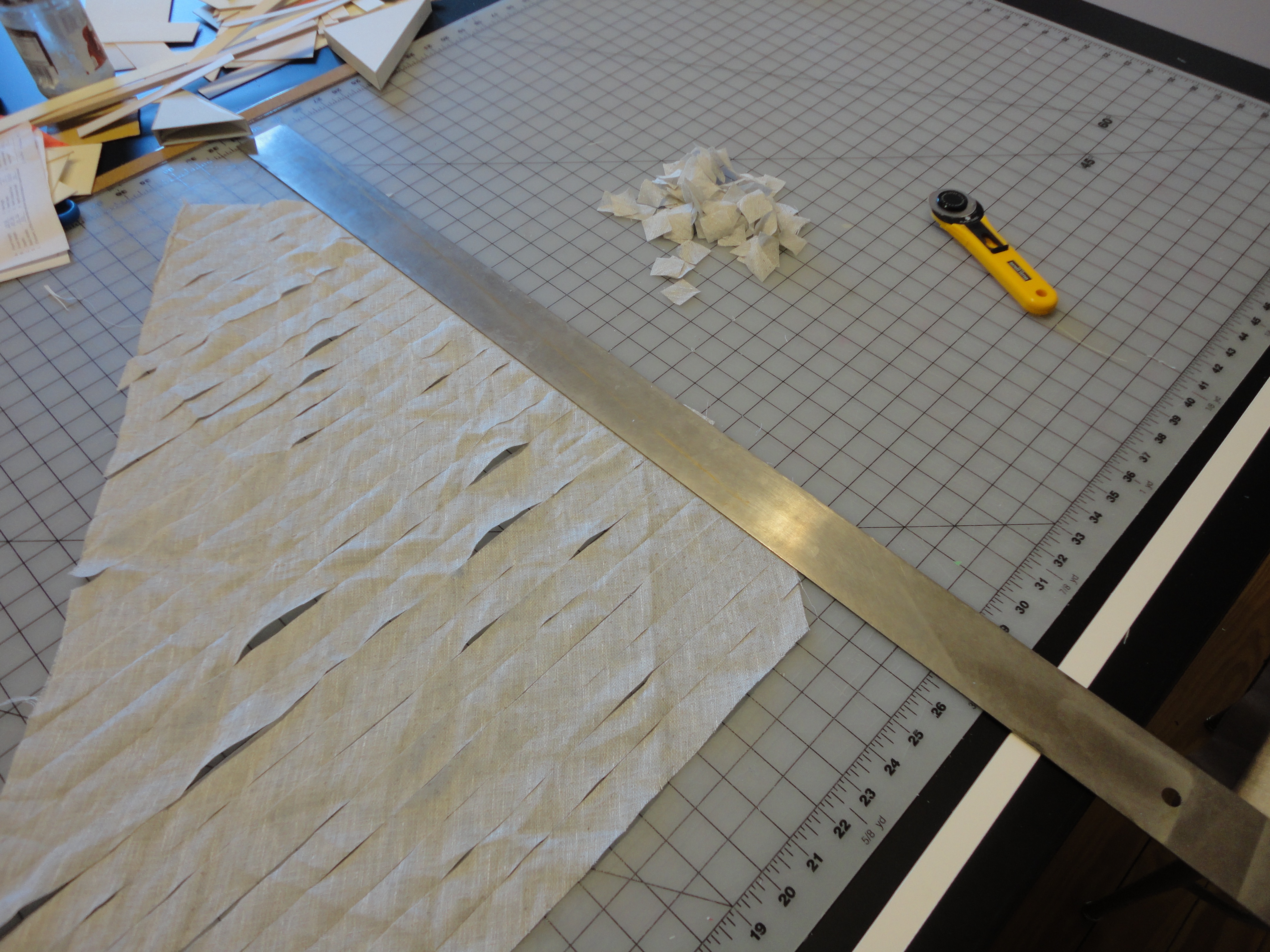 Cutting the linen fabric into tiny pieces so it can be beaten.